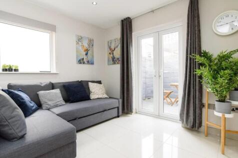 Bright lounge with patio doors and comfy sofa...