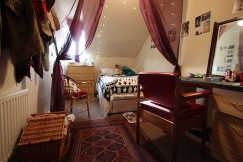 A cozy and well-maintained bedroom featuring a ...