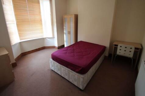 A bright double bedroom featuring a comfortable...