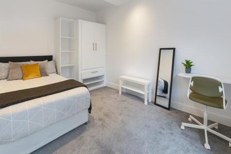 Bright, modern double bedroom with neutral deco...