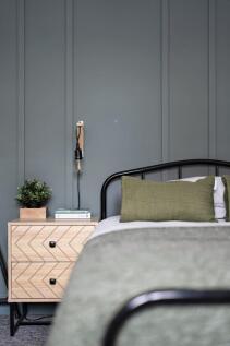 A stylish double bedroom featuring a modern bed...