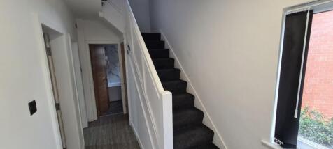 A tidy and well-maintained hallway featuring a ...