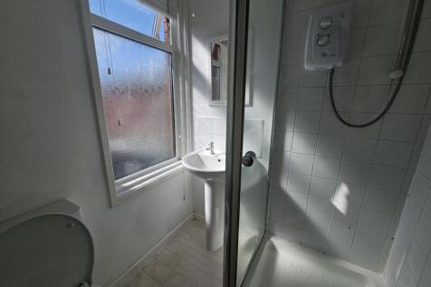 A clean and well-maintained bathroom with a sho...