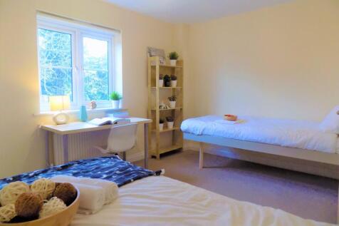 A bright and tidy double bedroom featuring two ...