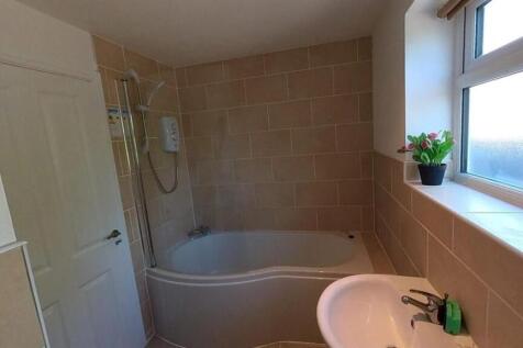 Bright bathroom suite with a modern bathtub...