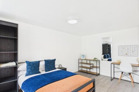 Bright, modern double bedroom with a comfortabl...