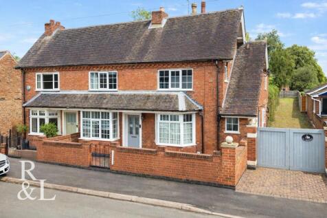 Symmetrical brick houses in sunlight.jpg