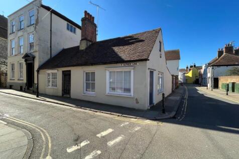 Corner cottage with bright exterior and streets...