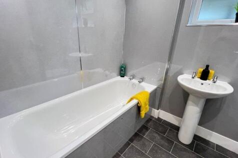 Modern bathroom with bath and bright finishes...