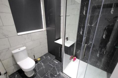 Modern bathroom with stylish dark marble tiles...