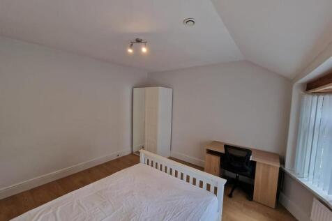 Bright, neutrally decorated double bedroom with...