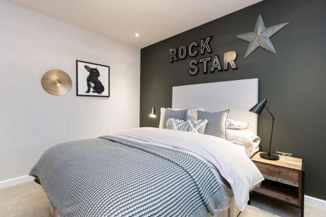 A cozy bedroom with a rock star-themed decor, featuring a large bed with a striped comforter