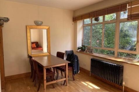 Bright living area with large windows and mirro...