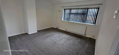 Bright, neutral double bedroom with large windo...