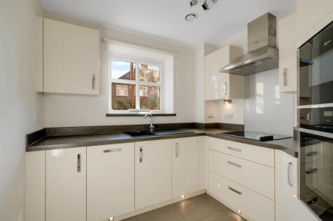 a kitchen with white cabinets
