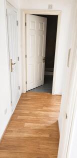 Bright hallway with stylish wood-effect floorin...