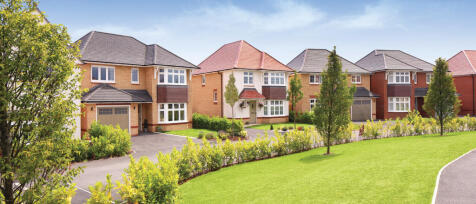 Aerial view of a modern residential neighbourhood with houses, roads, and green spaces in a rural se