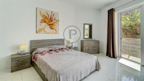 A modern bedroom with a double bed, adorned with a