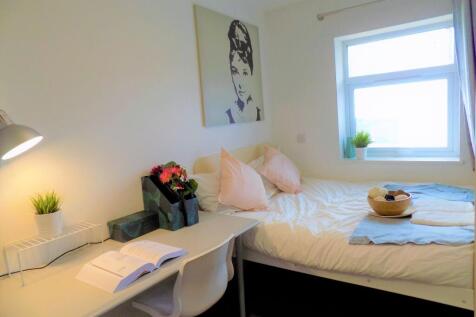 Bright and tidy single bedroom featuring a cozy...