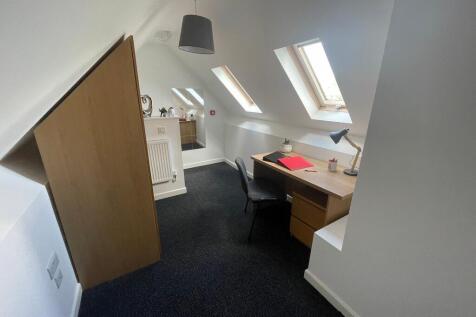 Bright attic single bedroom with three skylight...