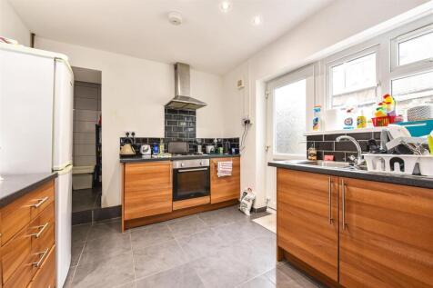 Modern kitchen with bright windows and sleek ti...