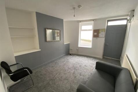 Bright lounge with sleek grey decor and sofa...