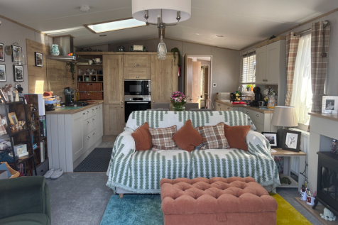 Spacious open plan lounge with log burner style fi