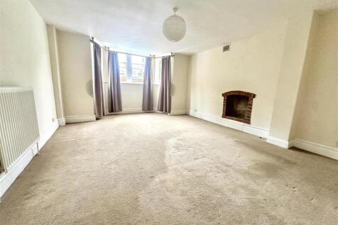 Bright and airy lounge with a charming fireplac...