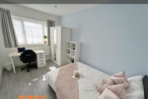 A bright and tidy single bedroom featuring a co...