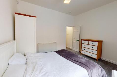Bright, neatly presented bedroom with a comfort...
