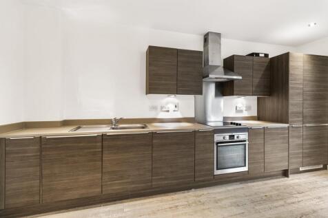 Experience culinary delight in this sleek modern kitchen with stylish finishes.