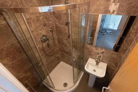 Modern tiled bathroom with sleek walk-in shower...