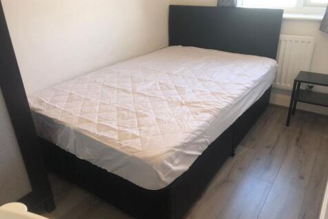 Bright, simply furnished bedroom with a comfort...