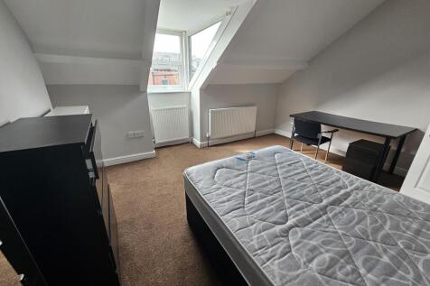 A neatly maintained bedroom with ample natural ...
