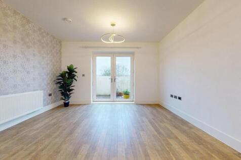 Bright, modern living room with light wood floo...