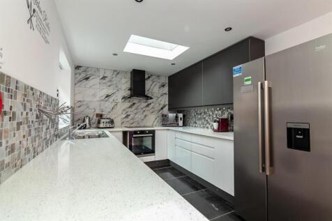 Modern kitchen with skylight and marble finish...