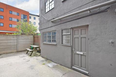 Private paved courtyard with a picnic bench, fe...