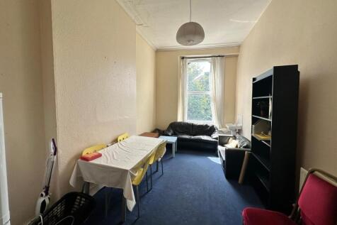 A spacious and bright living room with ample se...