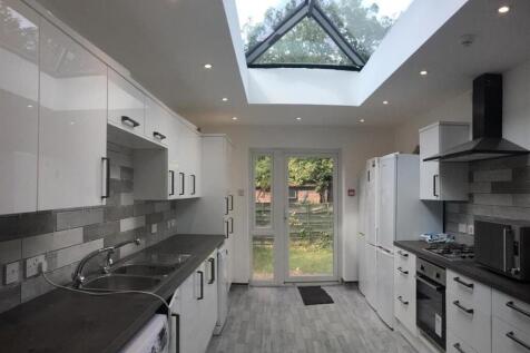 Bright modern galley kitchen with a large centr...