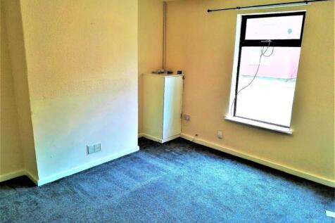 Bright bedroom with a large window, neutral dec...