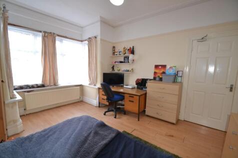 Bright furnished bedroom with a large bay windo...