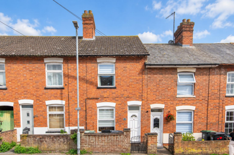 Sunny estate street with soft clouds.png