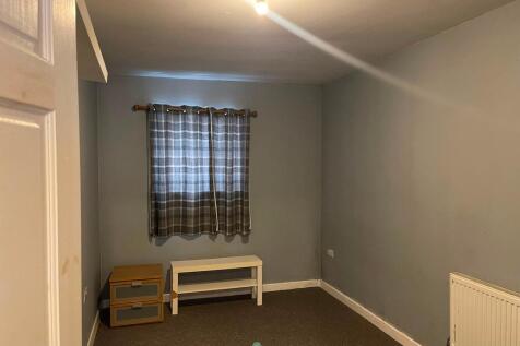 Cozy bedroom with neutral walls and soft lighti...