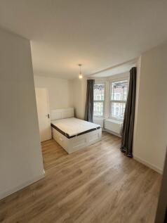 Bright and spacious double bedroom featuring la...