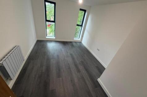 Modern room with sleek flooring and twin window...