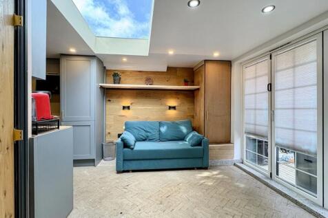 Bright modern lounge with skylight and sofa...