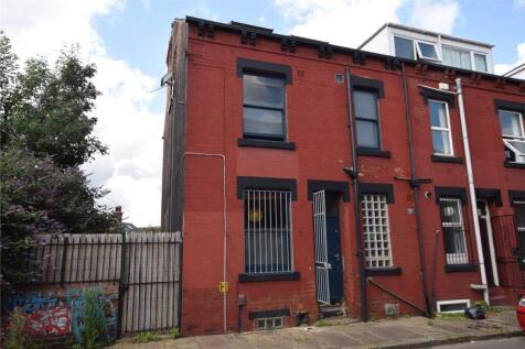 A red brick terraced house with black window fr...