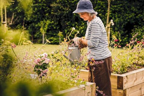 a man holding a bucket of flowers