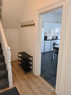 Bright and tidy hallway featuring light wooden ...