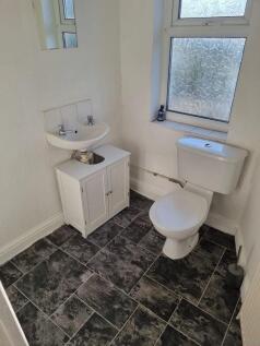 Clean, simply fitted bathroom with frosted wind...